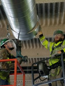 RBI employees working on ducts