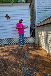 RBI employee power washing at United Way's Day of Action