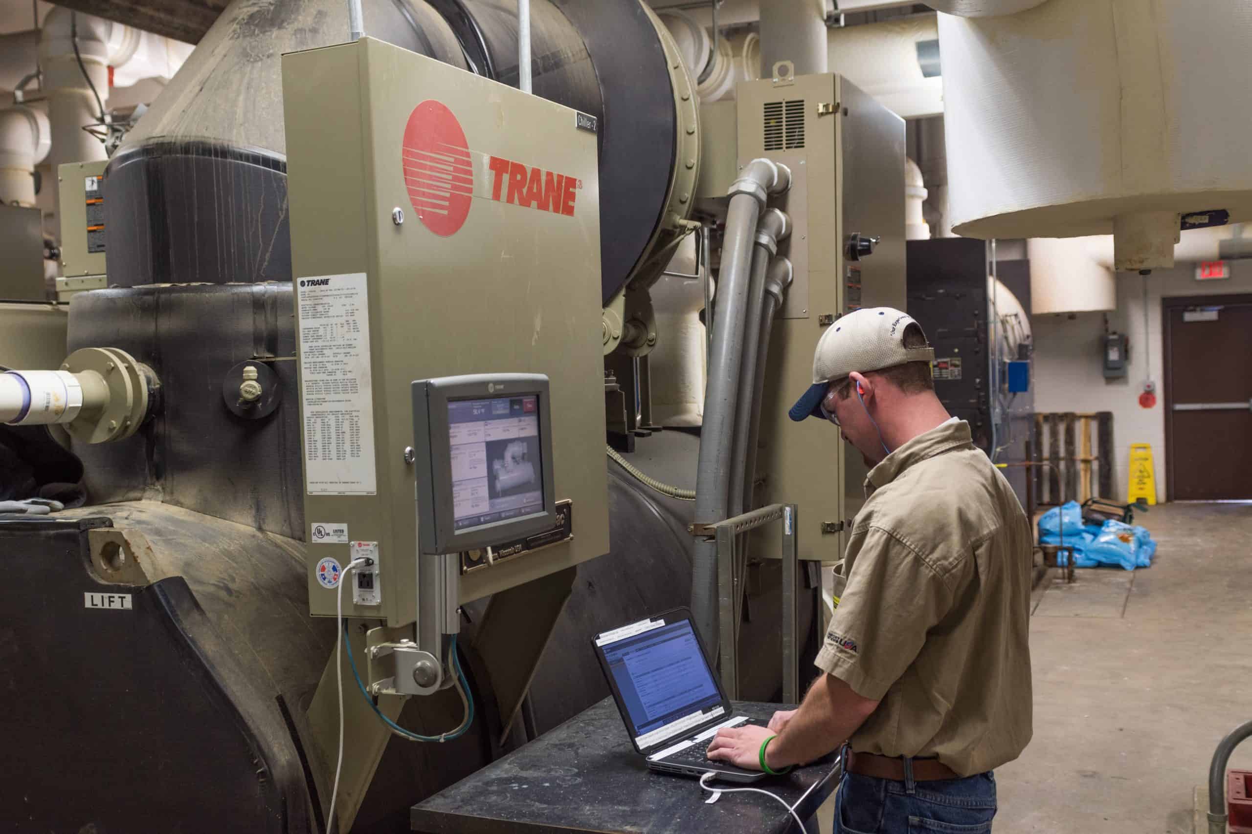 HVAC technician inspecting a digital report for a commercial HVAC system.