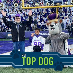 RBI's Top Dog Winner with the JMU mascot on JMU's football field.