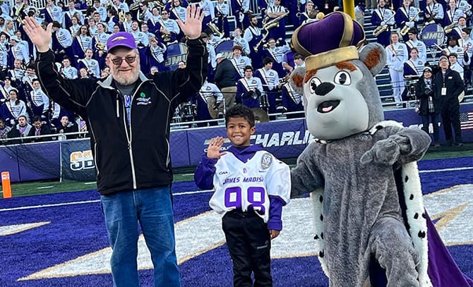 RBI-About-Community-2023-Top-Dog Top dog winner with JMU's mascot on the field
