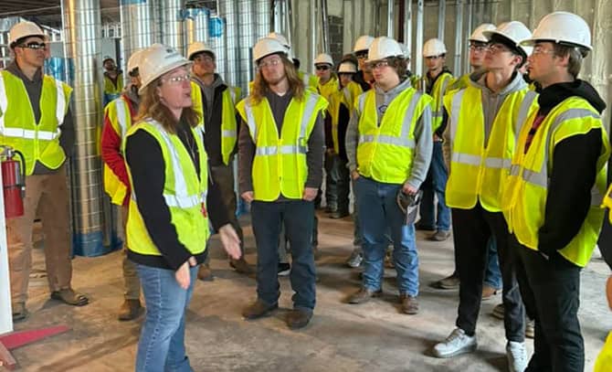 RBI-About-Community-2024-Triplett-Tech-Visit Students in construction vests touring a job site