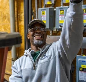 An RBI service technician smiling looking up while performing maintenance