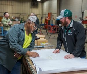 RBI employees reviewing plans in RBI's pre-fab shop