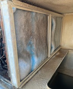 A dirty filter inside a commercial HVAC unit