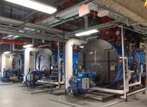 Three commercial boilers in a boiler room