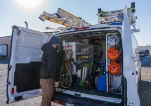 RBI service team member unloading maintenance tools out of an RBI van